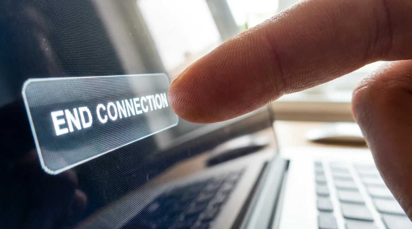Close-up of a finger clicking a button on a screen to disconnect a remote session.